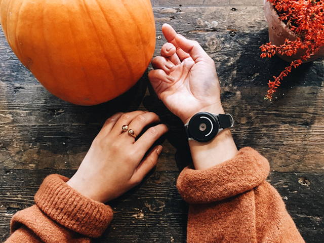 woman wearing doppel near pumpkin