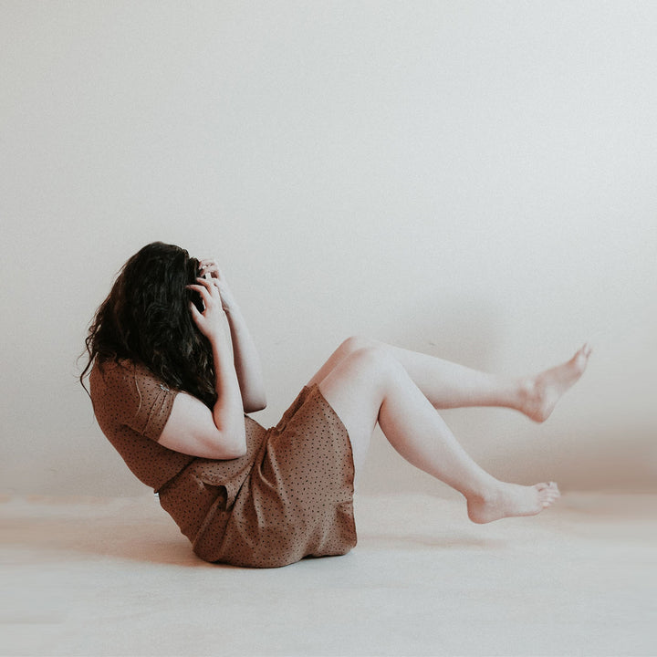 Women in brown dress distressed and distracted