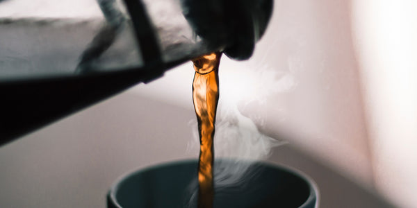 Coffee being poured into a cup steaming Caffeine Anxiety