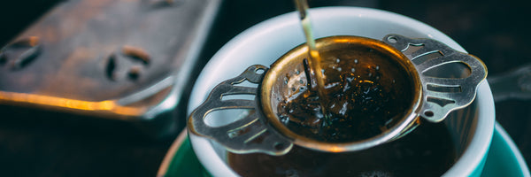 @mattseymour tea poured through filter into porcelain teacup